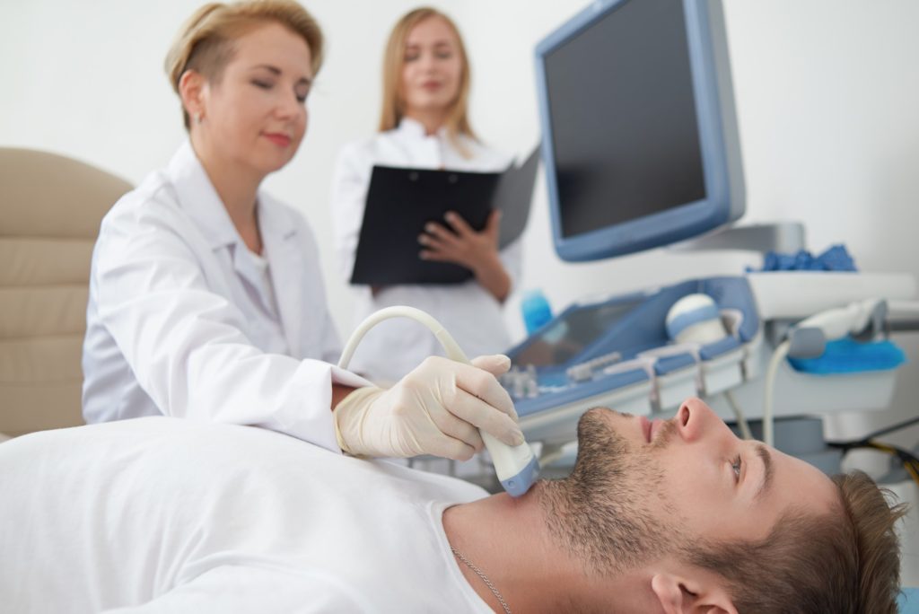 Doctor doing ultrasound diagnostics
